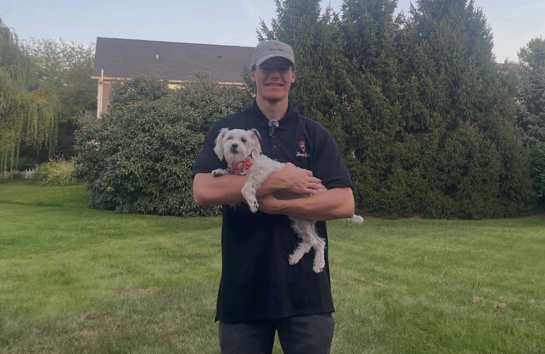 Sharp Lights owner holding his dog outdoors