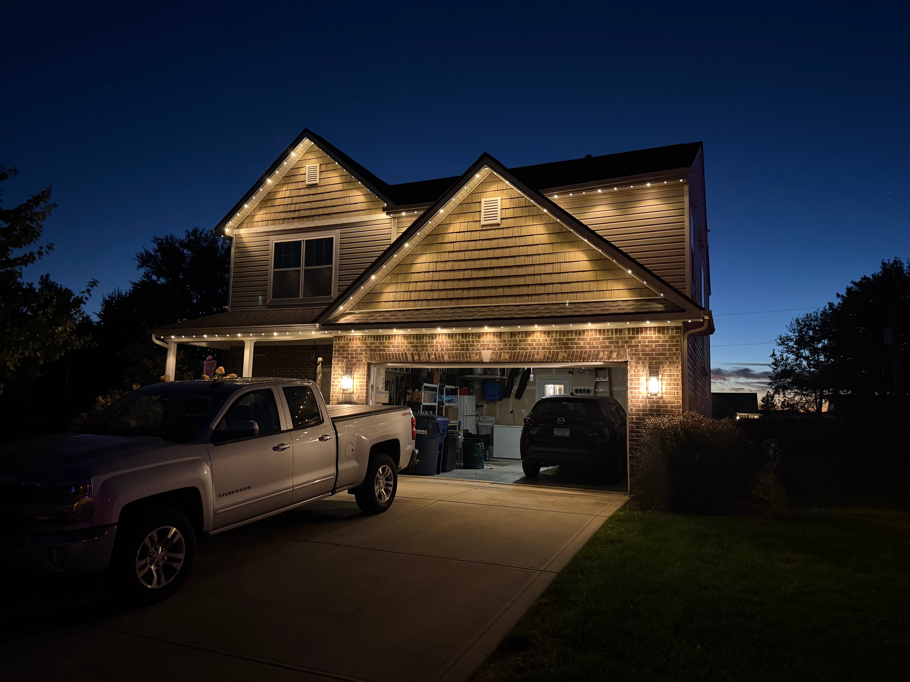 House with permanent LED roofline lights in warm white at dusk