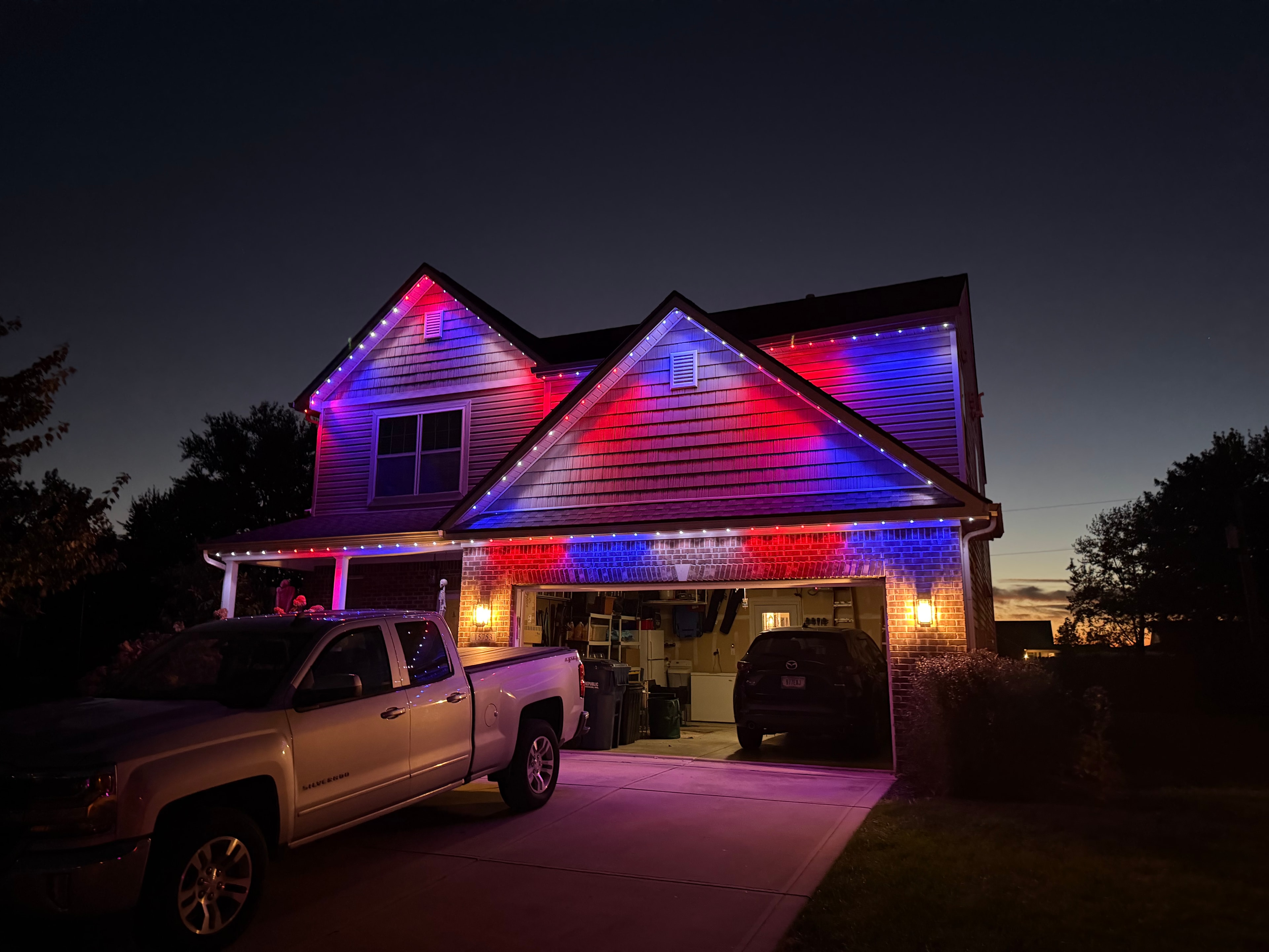 Same house lit up in red and blue permanent LEDs for game day at night