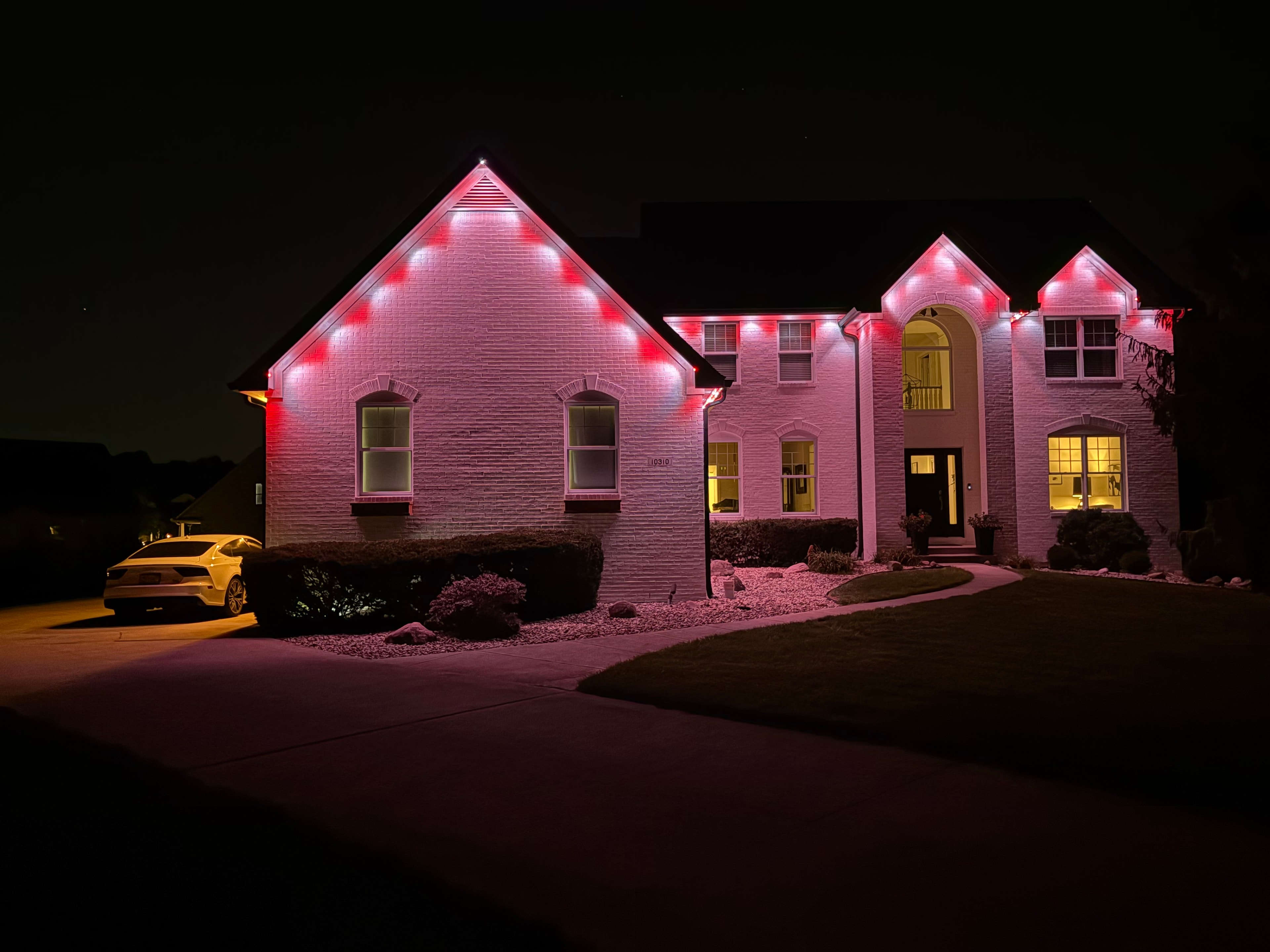 Home with candy cane permanent LED roofline lighting