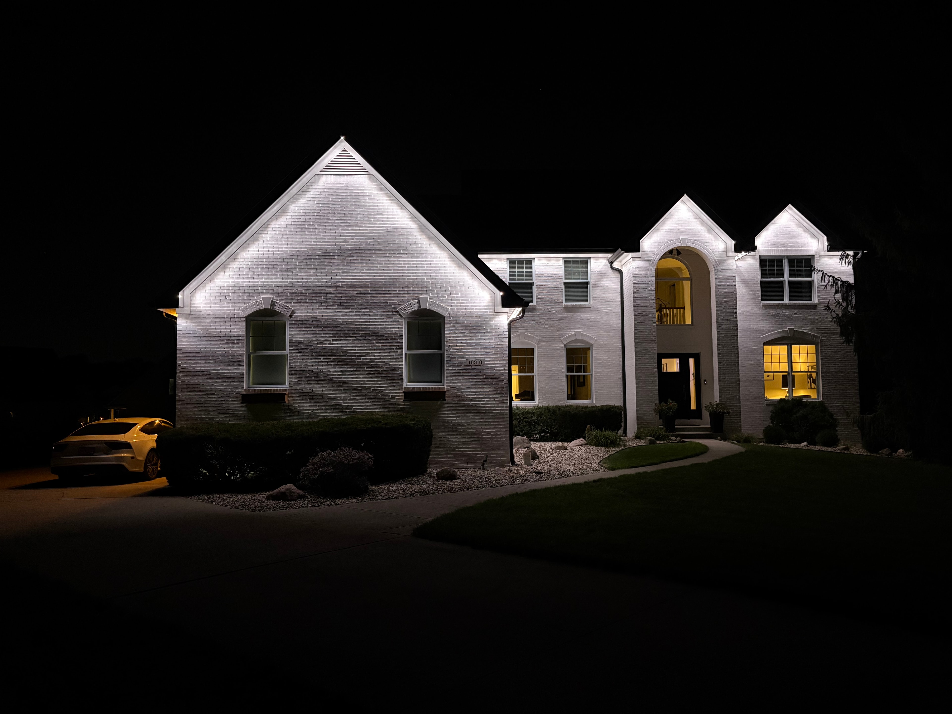 Home illuminated in white permanent LED roofline lighting
