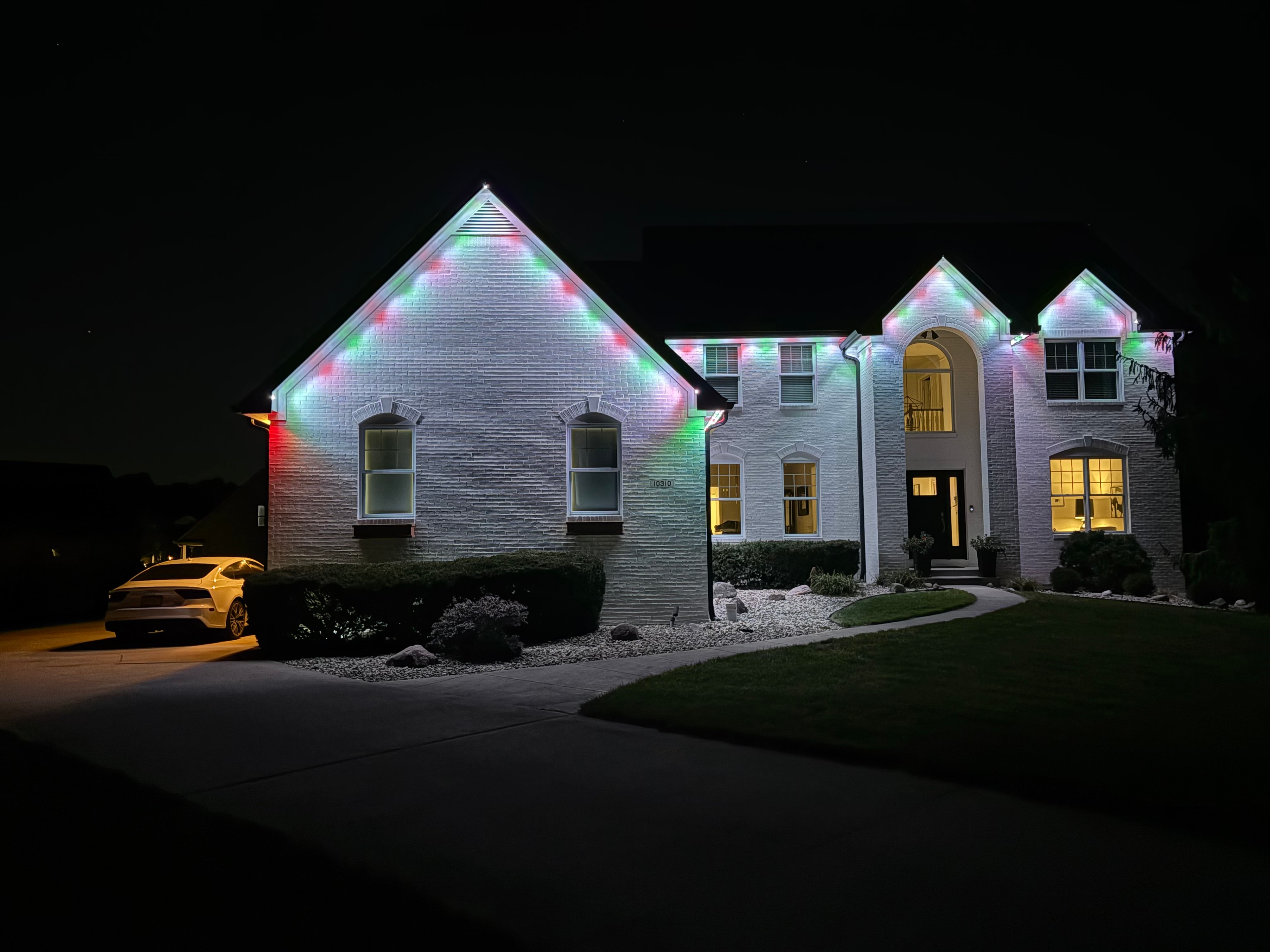 Home with multicolor Christmas permanent LED roofline lighting